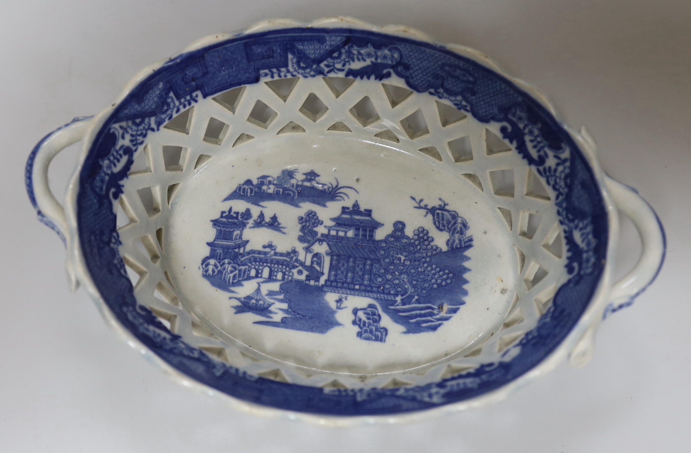 A late 18th century blue and white pearlware jug, a chestnut basket and a Pratt type jug (3), 21.5cm high